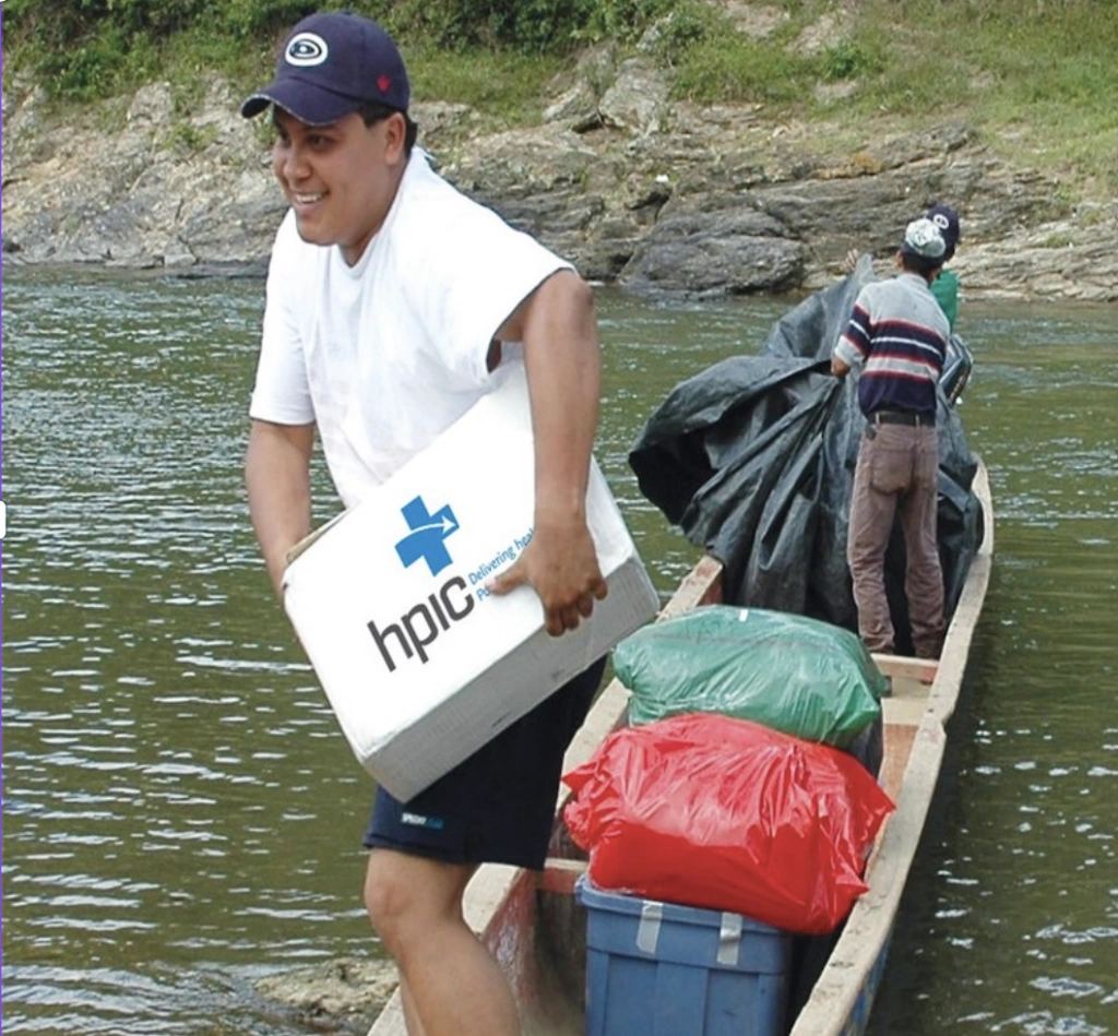 man in boat with medical supplies